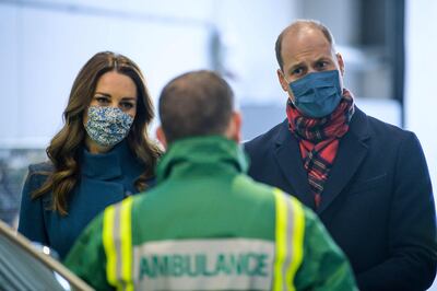 Britain's Prince William, Duke of Cambridge (R) and Britain's Catherine, Duchess of Cambridge (L) speak with staff during a visit to the Scottish Ambulance Service Response Centre in Newbridge, west of Edinburgh in Scotland on December 7, 2020, on their first full day of engagements on their tour of the UK. During their trip, their Royal Highnesses hope to pay tribute to individuals, organisations and initiatives across the country that have gone above and beyond to support their local communities this year. / AFP / POOL / POOL / Wattie Cheung
