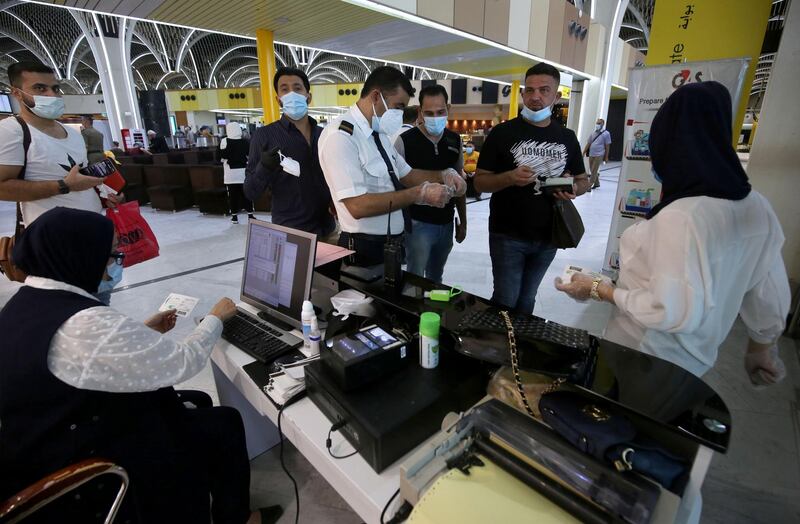 Passengers at a gate.   AFP