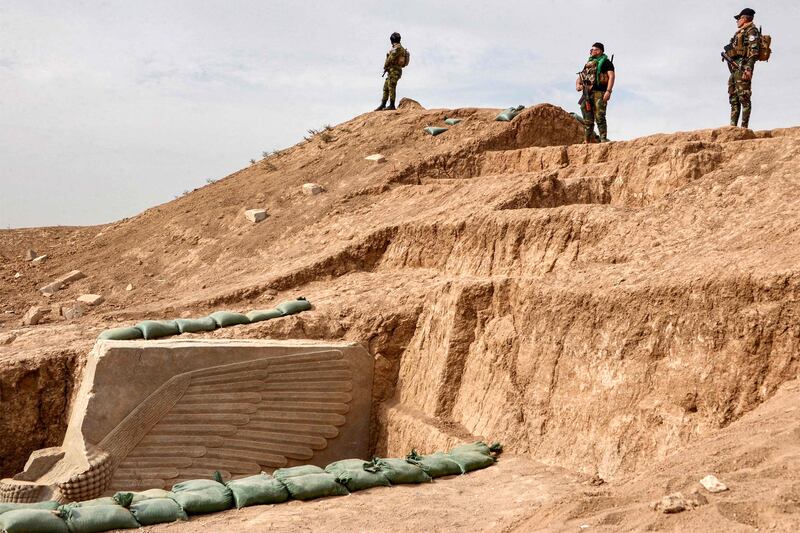 Iraqi security forces stand guard at the site. It had been buried in situ by the Iraqi State Board of Antiquities and Heritage to protect it during the conflict and it has emerged remarkably unscathed. AFP