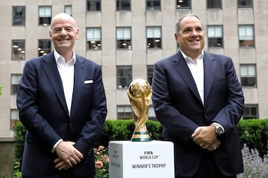 FIFA President Gianni Infantino (C), and Vice President Vittorio Montagliani (R), pose for photographers with the FIFA World Cup trophy at Radio City in New York, New York, USA, 16 June 2022. The North American cities hosting the 2026 World Cup were announced, eleven sites are in the US, three are in Mexico, and two in Canada.   EPA / Peter Foley