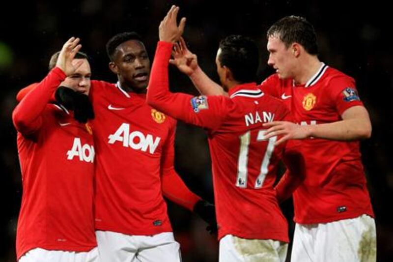 MANCHESTER, ENGLAND - DECEMBER 10:  (L-R) Wayne Rooney of Manchester United is congratulated by teammates Danny Welbeck, Nani and Phil Jones after scoring his team's second goal during the Barclays Premier League match between Manchester United and Wolverhampton Wanderers at Old Trafford on December 10, 2011 in Manchester, England.  (Photo by Alex Livesey/Getty Images)