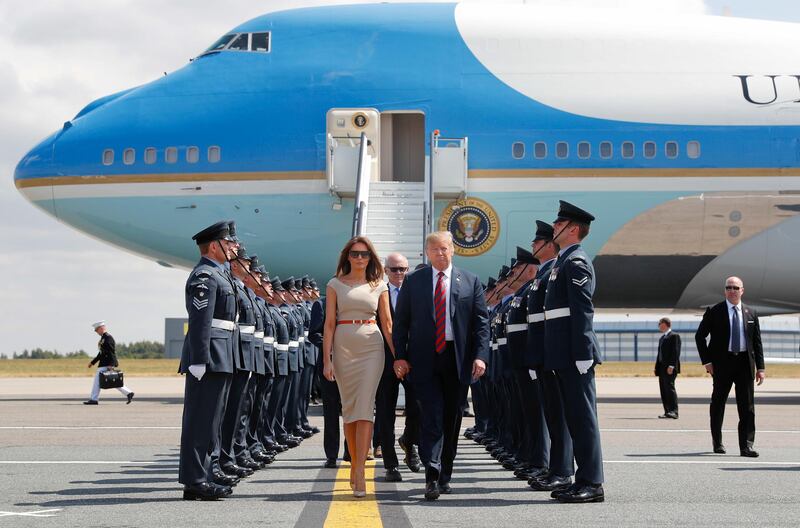 US President Donald Trump and first lady Melania Trump walk across the tarmac after stepping off Air Force One as they arrive at London's Stansted Airport. AP Photo