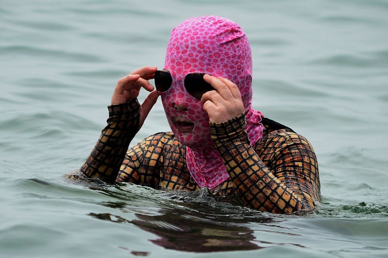 A woman wearing a facekini in the sea off Qingdao, in eastern China's Shandong province. AFP