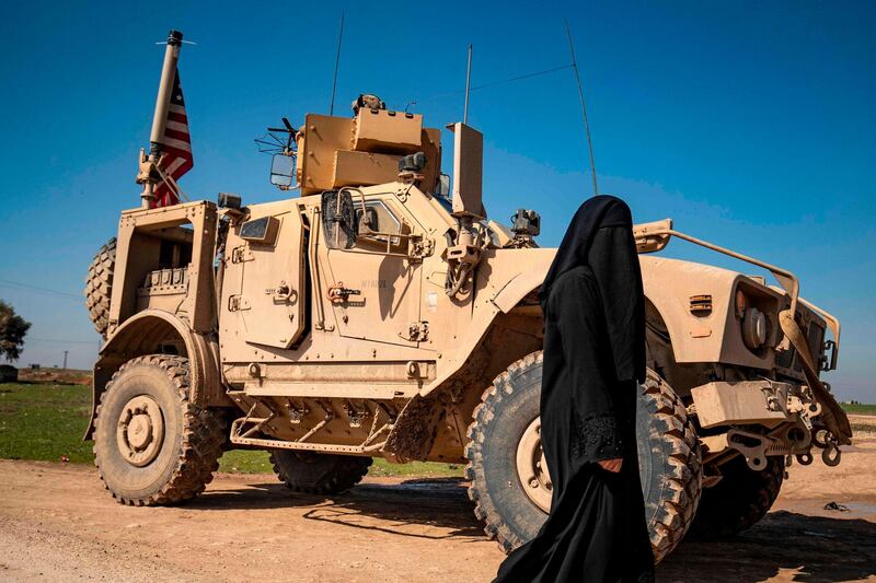 A US military armoured vehicle patrols on the outskirts of Tal Tamr town along the M4 highway in the northeastern Syrian Hasakeh province, near the border with Turkey.  AFP