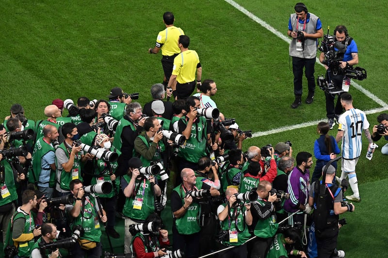 The scramble to capture Messi's moment. AFP