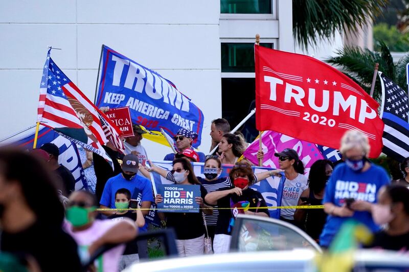 Supporters of President Donald Trump demonstrate as Democratic  vice presidential candidate Kamala Harris speaks at Palm Beach State College in Lake Worth, Florisa. AP Photo