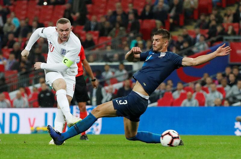 England's Wayne Rooney shoots at goal as Matt Miazga of the U.S. attempts to block Action. Reuters