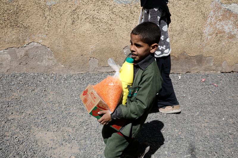 A boy carries aid supplies in Sanaa, Yemen, one of the countries affected by prolonged war. EPA