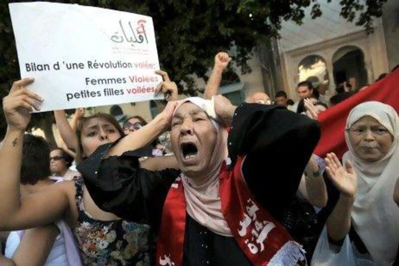 Tunisian women protest against violence against females outside a court in Tunis where a young Tunisian woman, allegedly raped by two policemen, was to face charges of indecency with her fiance.