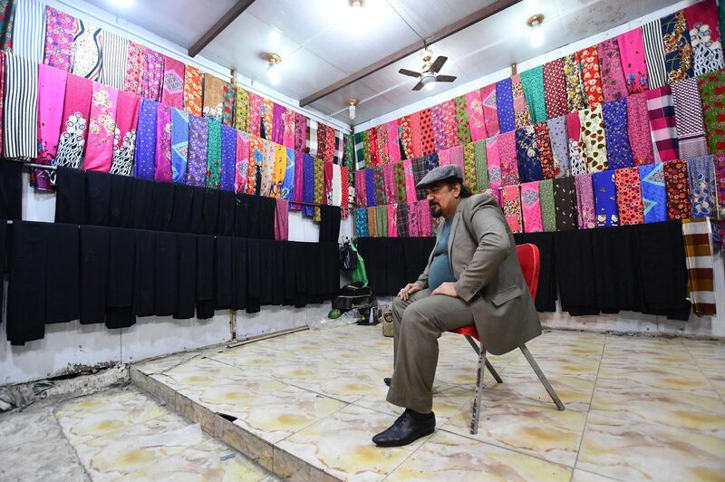A man waits for customers inside his fabric shop in the southern Iraqi city of Nasiriyah in the Dhi Qar province. AFP