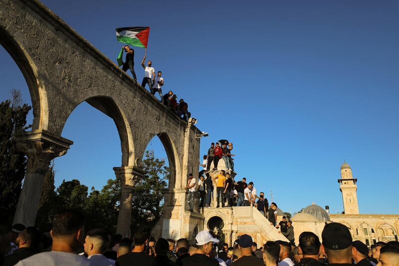 Palestinian flags fly at the compound that houses Al Aqsa mosque in Jerusalem's Old City, amid Israel-Gaza fighting. Reuters