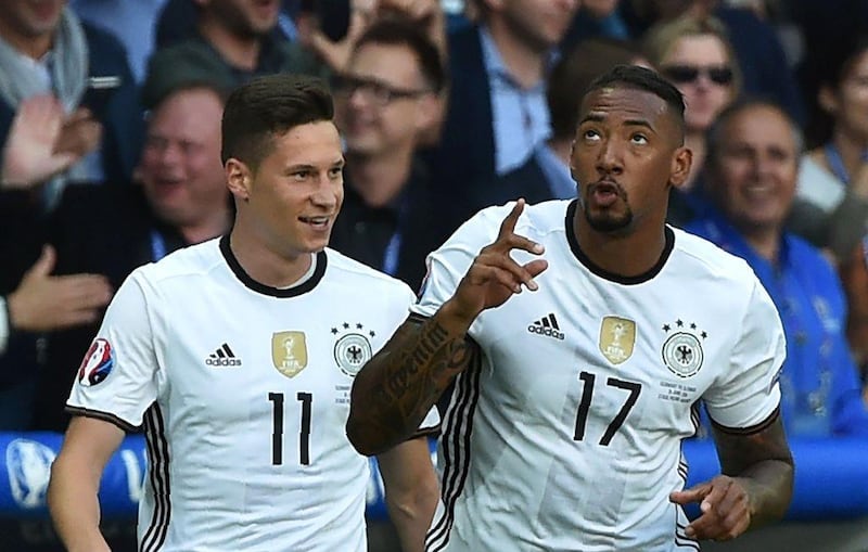 Germany's Jerome Boateng, right, and Julian Draxler celebrate a goal against Slovakia on Sunday. Philippe Huguen / AFP / June 26, 2016  