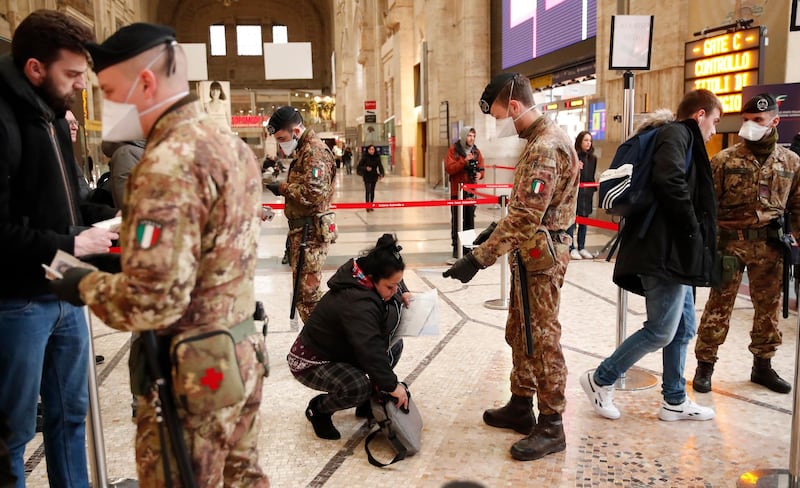 Police officers and soldiers check passengers leaving from Milan main train station, Italy, Monday, March 9, 2020. AP Photo