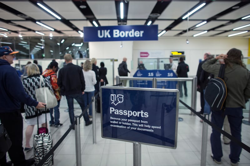 Border control at Gatwick Airport, south of London. The UK Is phasing out physical immigration status documents. Getty Images