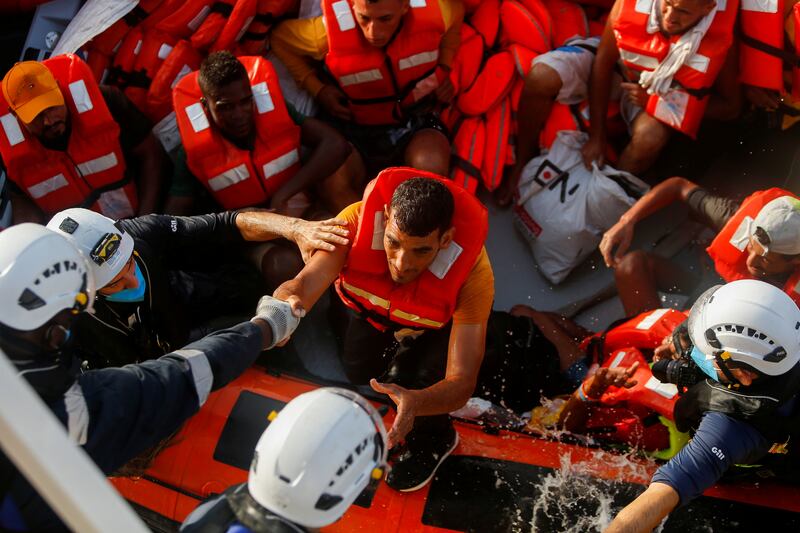 .A migrant prepares to board the German NGO migrant rescue ship ‘Sea-Watch 3’ from an inflatable boat after 12 asylum seekers were rescued from international waters north of Libya.