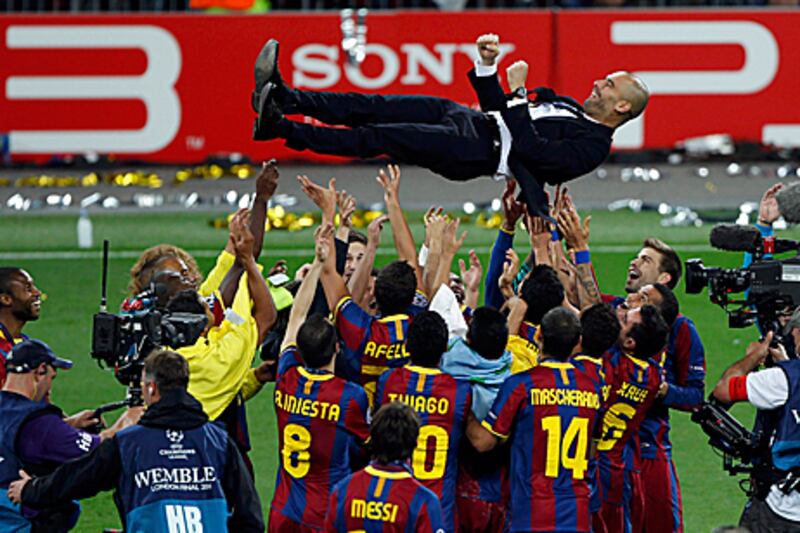 Pep Guardiola, the Barcelona coach, is thrown into the air by his jubilant players following their victory against Manchester United at Wembley Stadium on Saturday.