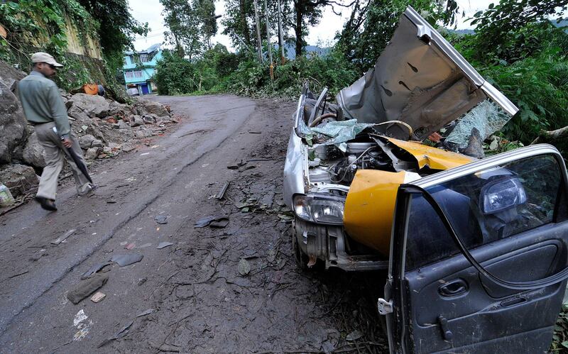 epa02926262 A car, which was destroyed in the earthquake two days previously, is seen near Gangtok town, northeast India, 20 September 2011. Villagers and rescuers struggled to reach victims in remote Himalayan villages amid heavy rains and landslides after a strong earthquake killed 69 people and damaged over 100,000 houses across north-eastern India, Nepal, Tibet and Bhutan, news reports said.  EPA/STR *** Local Caption ***  02926262.jpg