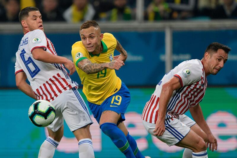 Brazil's Everton drives the ball past Paraguay's Richard Sanchez, left, and Ivan Piris. AFP