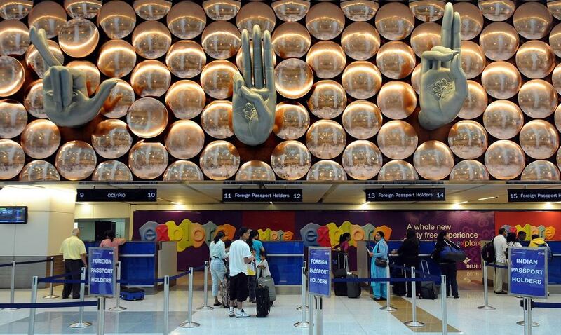 Transit passengers pass through immigration counters at Terminal T-3 of Indira Gandhi International Airport in New Delhi. Tourists travelling to India from 180 countries will no longer have to queue at their local consulates to obtain visas after New Delhi announced a 'very significant' overhaul of its border controls. Prakash Singh / AFP