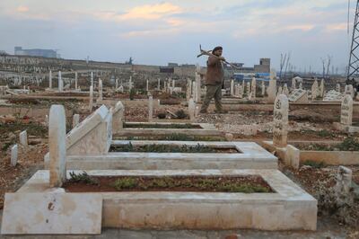 Idlib’s tombstones stretch as far as the eye can see, bathed in a soft orange light as the sun sets. Abd Almajed Alkarh for The National.