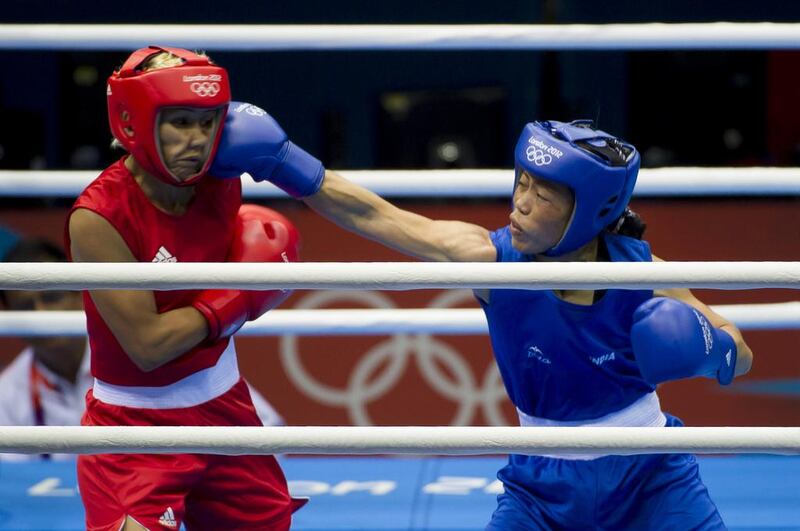 MC Mary Kom, left, competes against Maroua Rahali of Tunisia during the flyweight quarter-finals at the 2012 London Olympic Games. Jonathan Short / AP Photo 