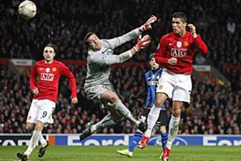 Manchester United's Cristiano Ronaldo, right, heads past the Inter Milan goalkeeper Julio Cesar.