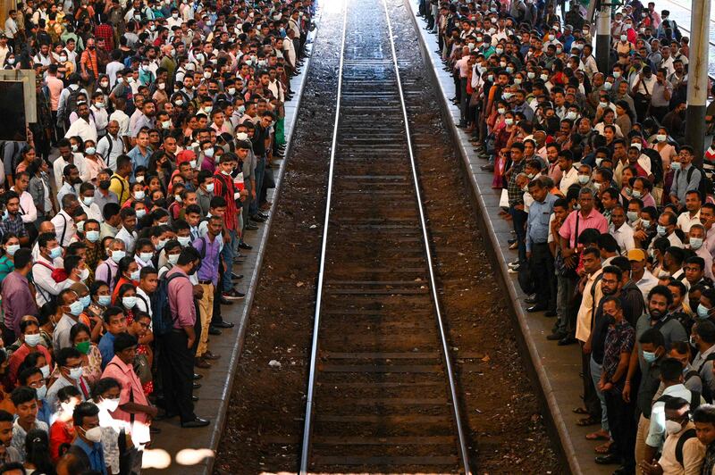Commuters wait to board a train at the Fort railway station during a nationwide strike in Colombo, Sri Lanka. AFP