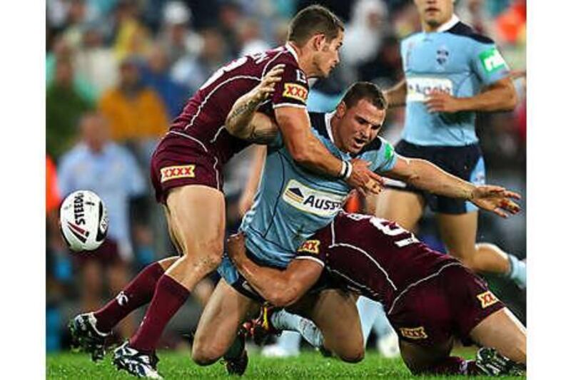 Anthony Watmough, of NSW, is thwarted by the Queensland defence during yesterday's defeat to the Maroons.