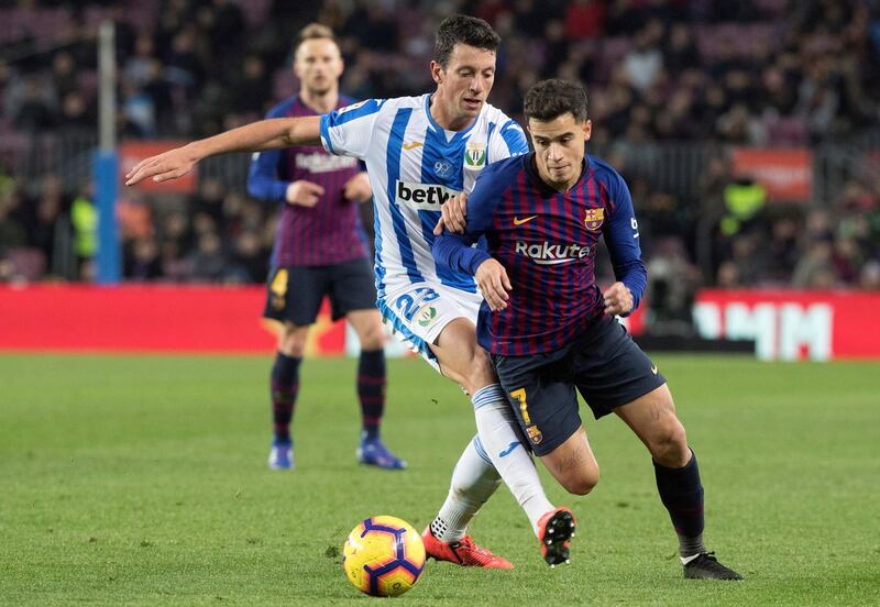 Barcelona midfielder Philippe Coutinho tussles with Mikel Vesga. EPA