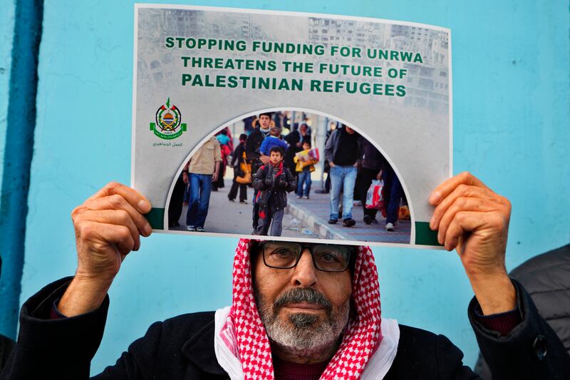 A Palestinian supporter holds a placard during a protest against the UNRWA funding cuts, in Beirut, Lebanon, on January 30. AP