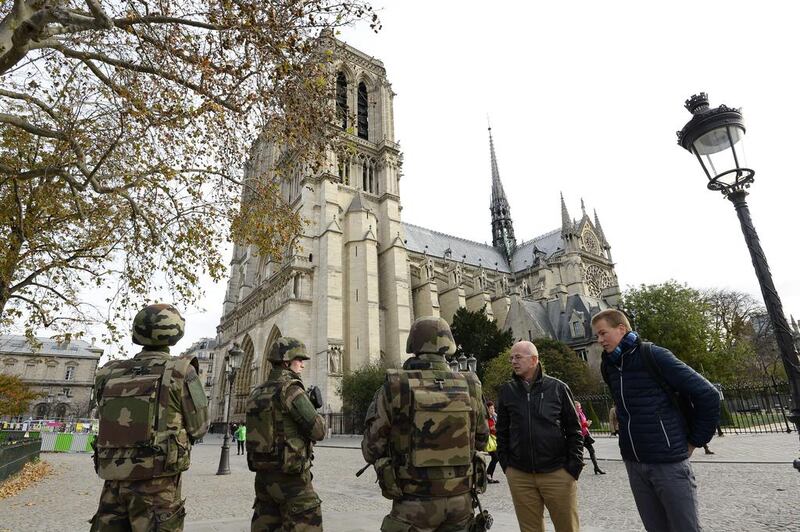 French soldiers patrol in front of Notre-Dame de Paris Cathedral in Paris on November 14, 2015. According to witnesses, at least 5 people were killed in the immediate area by attackers wielding automatic rifles. Bertrand Guay/AFP Photo