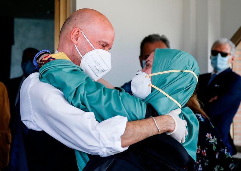 Italian volunteer aid worker Silvia Costanza Romano (R), who was kidnapped in Kenya in late 2018, wearing a khimar and face mask,  embraces her father Enzo  upon her arrival at Rome’s military Ciampino airport on May 11, 2020, following her release.  Silvia Romano was 23 and working as a volunteer in the orphanage in Chakama village in southeast Kenya when she was seized by gunmen in November 2018.
 - Italy OUT / ITALY OUT
 / AFP / ANSA / FABIO FRUSTACI / ITALY OUT
