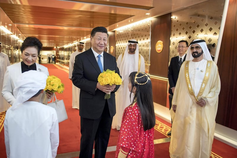 ABU DHABI, UNITED ARAB EMIRATES - July 19, 2018: HE Xi Jinping, President of China (C) is presented with flowers upon his arrival at the Presidential Airport. Seen with HH Sheikh Mohamed bin Rashid Al Maktoum, Vice-President, Prime Minister of the UAE, Ruler of Dubai and Minister of Defence (R) and HH Sheikh Mohamed bin Zayed Al Nahyan, Crown Prince of Abu Dhabi and Deputy Supreme Commander of the UAE Armed Forces (back 2nd R), and Peng Liyuan, First Lady of China (back L).

( Saif Al Muhairi / Government of Dubai Media Office )
---