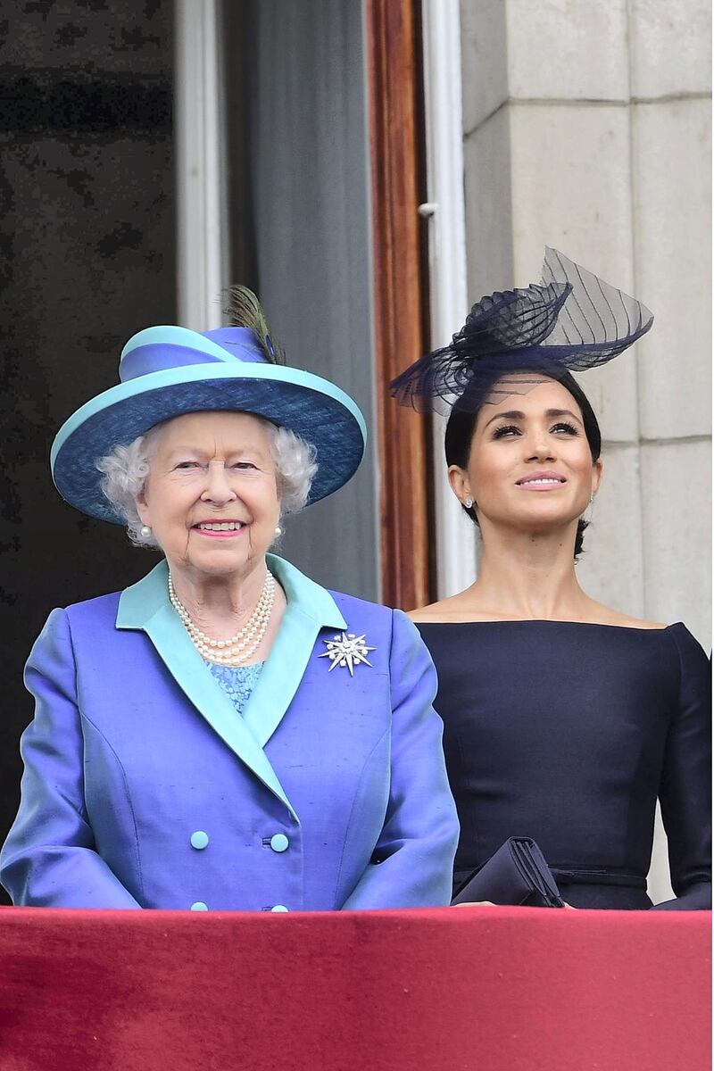 LONDON, ENGLAND - JULY 10: LONDON, ENGLAND - JULY 10:  Queen Elizabeth II and Meghan, Duchess of Sussex watch the RAF 100th anniversary flypast from the balcony of Buckingham Palace on July 10, 2018 in London, England. (Photo by Paul Grover - WPA Pool/Getty Images)