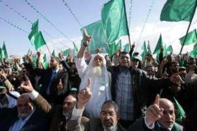 GAZA CITY, GAZA - DECEMBER 14:  Hamas supporters wave flags and shout slogans as they gather at a mass rally on December 14, 2008 in Gaza City, Gaza Strip. Hundreds of thousands attended the Hamas rally to mark the 21st anniversary of the founding of the militant group, Hamas. (Photo by Abid Katib/Getty Images)