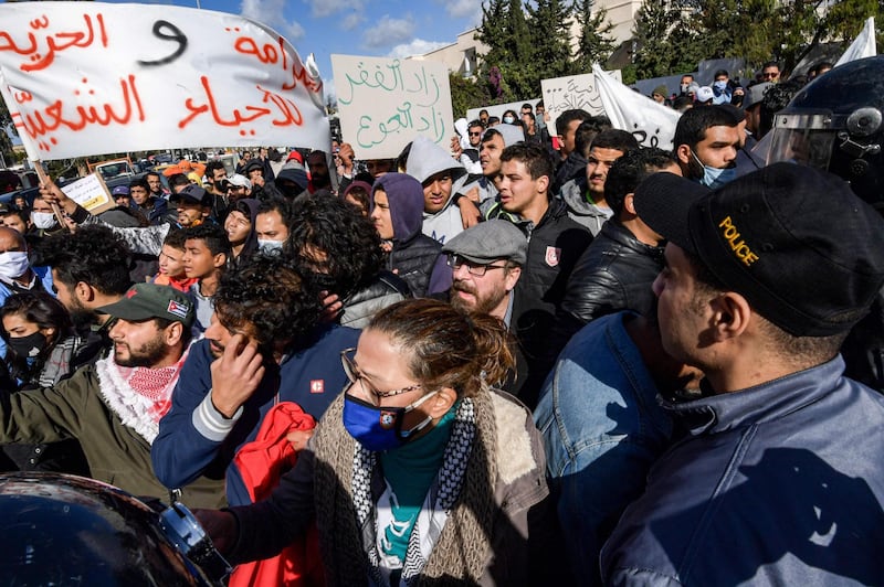 Security forces confront protesters from the Ettadhamen city suburb on the northwestwern outskirts of Tunisia's capital Tunis as they prevent them from passage onwards to reach an anti-government demonstration outside the Tunisian Assembly headquarters.  AFP