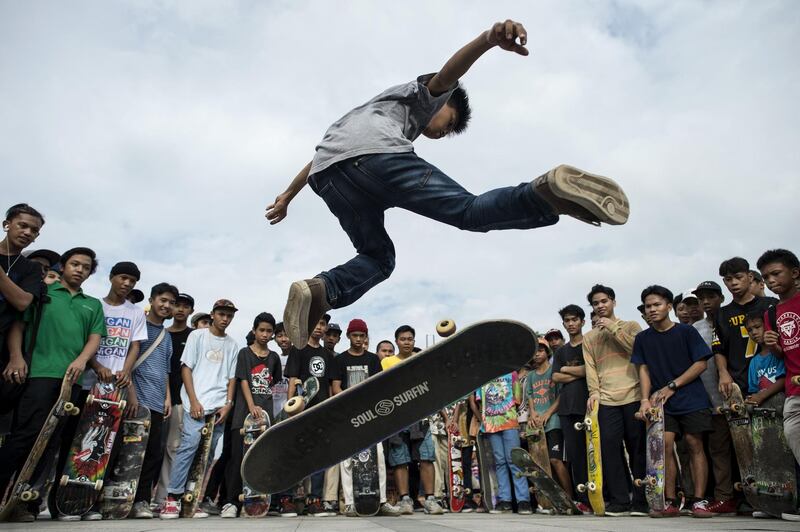 A boy performs a trick during an event to mark Go Skateboarding Day in Manila. Noel Celis / AFP Photo
