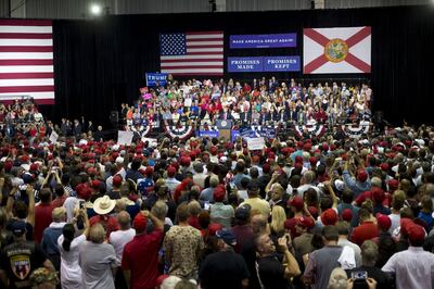 U.S. President Donald Trump, center, addresses the crowd during a rally in Tampa, Florida, U.S., on Tuesday, July 31, 2018. Iranian Foreign Minister Javad Zarif pushed back on Trump's suggestion that he'd be willing to meet President Hassan Rouhani with "no preconditions," saying the two countries spent plenty of time in negotiations already. Photographer: Zack Wittman/Bloomberg