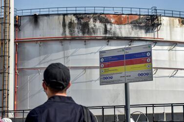 A man looks at a damaged silo a day after an attack at the Saudi Aramco oil facility in Saudi Arabia's Red Sea city of Jeddah, on November 24, 2020.  AFP 