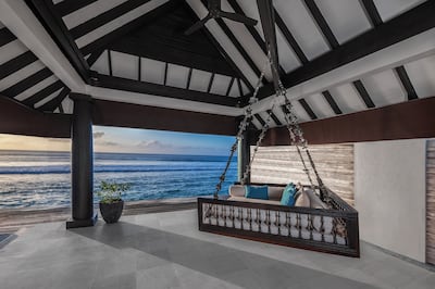 A suspended day bed on the terrace of an Ocean House. Photo: Naladhu Private Island