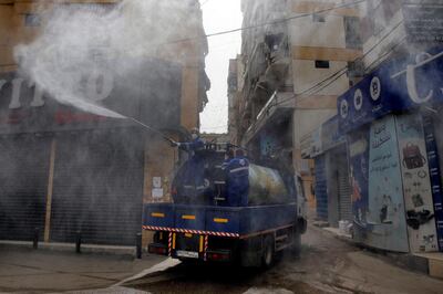 In this Friday, March 27, 2020 photo, members of the Islamic Health Society, an arm of the Iran-backed militant Hezbollah group sprays disinfectants as a precaution against the coronavirus, in a southern suburb of Beirut, Lebanon. Hezbollah has mobilized the organizational might it once deployed to fight Israel or in Syria's civil war to battle the spread of the novel coronavirus. It aims to send a clear message to its Shiite supporters that it is a force to rely on in times of crisis -- particularly after it suffered a series of blows to its prestige. (AP Photo/Bilal Hussein)