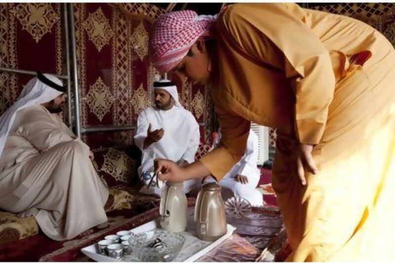 Saif Al Hamli, centre, and his family live in Al Dhafrah Marabiea, the closest residential area to Shams 1. Like many of their neighbours, the Al Hamli family keeps a traditional bedouin tent outside their home. The National