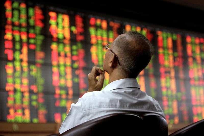 An investor monitors an electronic stock board in Bangkok, Thailand. Dario Pignatelli / Bloomberg