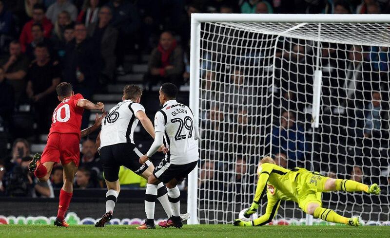 Liverpool’s Philippe Coutinho, left, scores their second goal. Paul Ellis / AFP