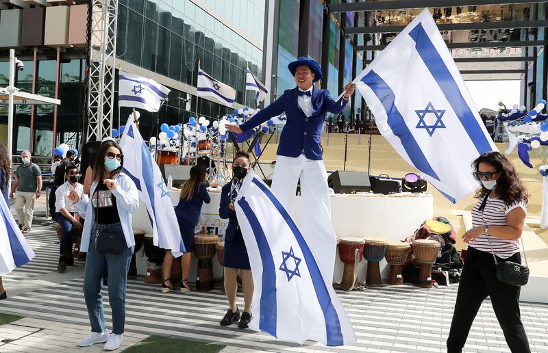 Performers and staff members hold Israeli flags at the Israel day celebration at Expo 2020  Dubai. All photos: Pawan Singh / The National