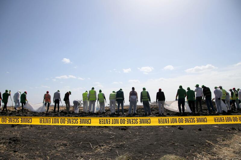 Forensic investigators and recovery teams collect personal belongings and other material from the crash site of Ethiopian Airlines Flight ET 302 in Bishoftu, Ethiopia. Getty Images