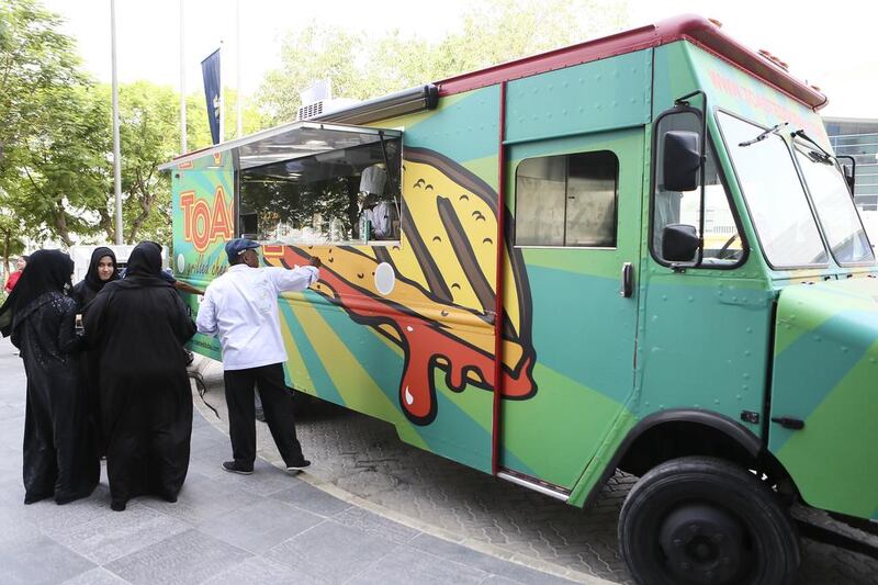 The first patrons gather outside the Toasted Dubai food truck at the Dubai Chamber of Commerce. Sarah Dea / The National