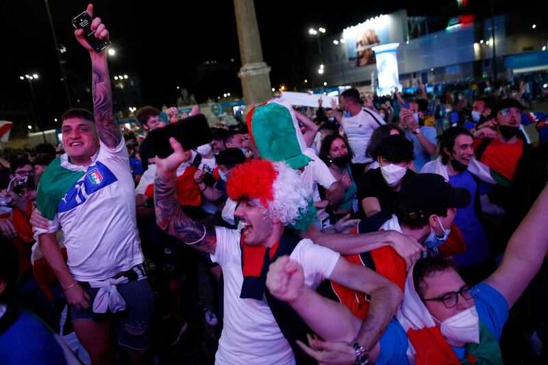 Italian fans celebrate as they watch their side beat Turkey 3-0 on giant screen in downtown Rome. AP