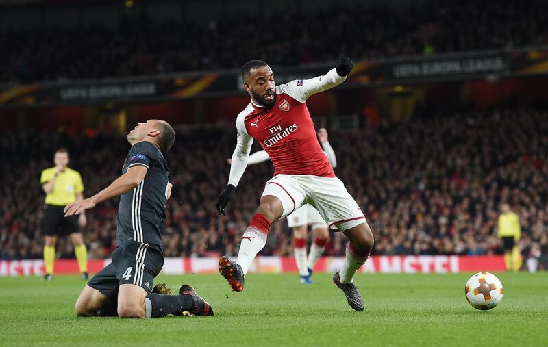 epa06648352 Arsenal's Alexandre Lacazette (R) in action against Moskow's Sergei Ignashevich (L) during the UEFA Europa League quarter final first leg soccer match between Arsenal FC and CSKA Moscow in London, Britain, 05 April 2018.  EPA/ANDY RAIN