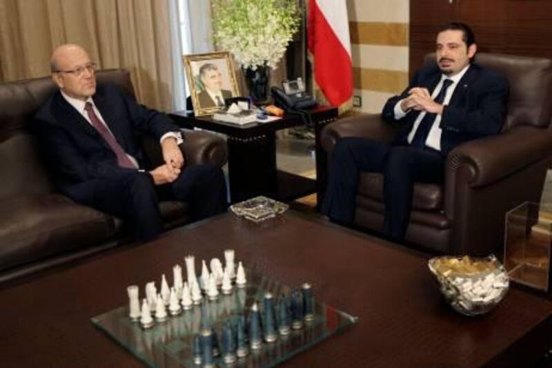 Lebanon's caretaker Prime Minister Saad Hariri, right, meets with Prime Minister-designate Najib Mikati, left, at Hariri's residence in Beirut, Lebanon, Wednesday, Jan. 26, 2011. Lebanon's new Hezbollah-backed prime minister began the process of forming a new Cabinet on Wednesday, as calm returned to the country after two days of protests against the Iranian-backed militant group's growing influence. (AP Photo/Hussein Malla) *** Local Caption ***  BEI108_Mideast_Lebanon_Politics.jpg